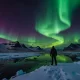 Solo holidays traveler experiencing the Northern Lights in Iceland